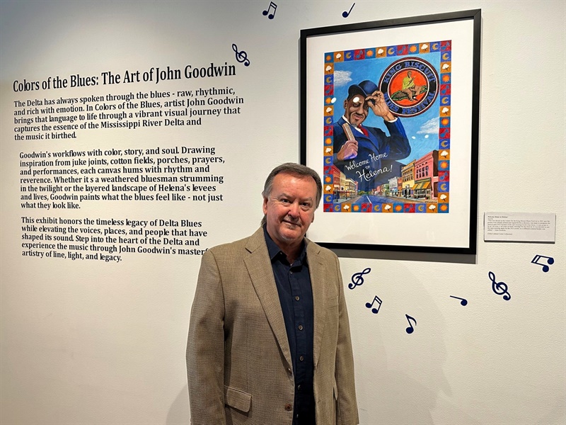John Goodwin Art Exhibit Featuring Artist Artist John Goodwin in a brown suit jacket standing in front of his new Exhibit.